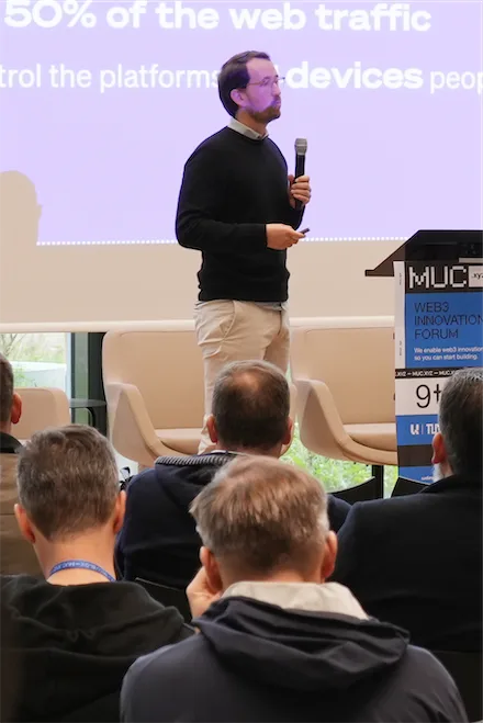 Bernhard Neumann mit Mikrofon bei einem Vortrag auf dem MUC Web3 Innovation Forum